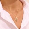 Gold-plated leaf charm necklace with a refined botanical silhouette