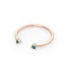 Emerald cuff ring with two green stones and silver setting