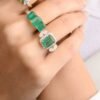 Sterling silver cocktail ring with prong-set emerald and CZ details