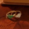 Pave-set emerald signet ring with a sleek, polished silhouette