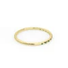 Emerald band ring with a graceful half eternity style