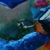 Gold-plated sterling silver ring with a polished emerald-coloured stone