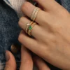 Orbit-inspired ring design with thick gold plating and green stone