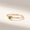 Delicate solitaire ring featuring a centred teardrop emerald stone