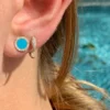 Classic stud earrings featuring a refined turquoise and diamond design