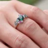 Teal green sapphire cluster engagement ring in sterling silver