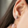 Elegant floral stud earrings with polished baguette-set CZ accents