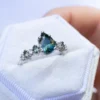 Sterling silver engagement ring with pear-cut green sapphire-inspired centre and diamonds