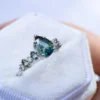 Elegant engagement ring featuring marquise and round green and diamond-inspired stones