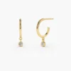 Sterling silver hoop earrings with dangling diamond accents
