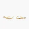 Dangling diamond detail adds a modern touch to hoop earrings