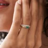Marquise-shaped emerald ring with bezel setting and gold plating
