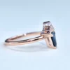 Gold-plated sterling silver ring featuring a teal sapphire centre stone