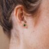 Minimalist sterling silver stud earrings with a green malachite stone