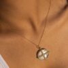Gold-plated silver pendant featuring a polished medallion silhouette