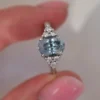 Oval light blue sapphire engagement ring with delicate pave accents