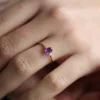Slim-band ring with oval and round CZ stones