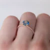 Sterling silver engagement ring with pastel blue sapphire and bright accents