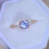 Pastel purple sapphire engagement ring with pear-shaped diamond accents