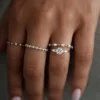 Round cut diamond ring with a seamless line of pave-set stones
