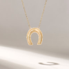 Horseshoe charm necklace with a simple, meaningful design