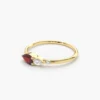Pear-shaped CZ ruby ring with prong-set diamond details