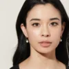 Elegant hoop earrings combining pearls with thick gold plating