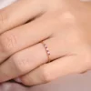 Silver ring with a petite blue sapphire and two diamond accents