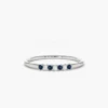 Petite three-stone ring with a deep blue sapphire centre
