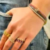 Sterling silver tennis bracelet featuring pave-set CZ stones and diamond letters