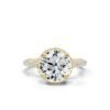 Round engagement ring accented with multiple side stones and a clean profile