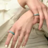 Round turquoise stones create a clean, colourful band ring design