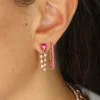 Ruby-inspired pear-shaped CZ stone earrings with polished loop design