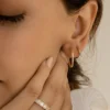 Classic huggie earrings with a row of sapphire stones