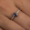 Silver ring featuring a pear-cut CZ sapphire and accent stones