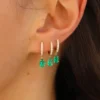 Single huggie earring with pear-shaped emerald drop