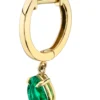 Single huggie earring featuring a pear-shaped emerald accent