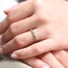 Ring with asymmetrical premium CZ emerald and diamond accents
