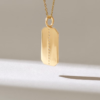 Necklace with a clean flat emerald-shaped charm and subtle sparkle