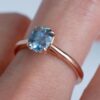 Teal blue sapphire solitaire ring set with gold plating and diamonds