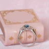 Engagement ring featuring an emerald cut teal centre stone