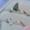 Teal blue sapphire engagement ring set with a kite-shaped centre stone