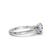 Three stone engagement ring with refined baguette-cut accents