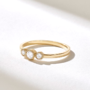 Modern engagement ring with a clean bezel-set trilogy silhouette
