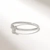 Minimal ring design with three stones and a refined profile