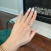 Cluster oval engagement ring with delicate cluster-inspired side stone detail