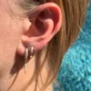 Dangle earrings featuring a distinctive horn shape and clean design