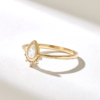 Elegant ring with a compact pear stone and refined top detail