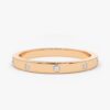 Wedding band featuring a smooth flush stone setting