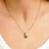 Solitaire heart pendant featuring a 6.5mm green stone